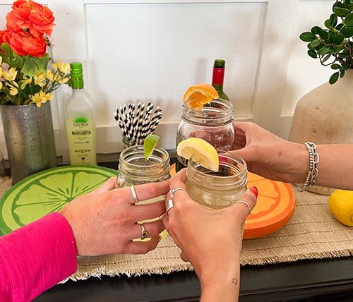 'Cheers' in front of fruit pedestal trays